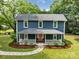 Charming two-story home with a welcoming front porch and landscaped yard at 9929 Kerns Rd, Huntersville, NC 28078