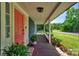 Inviting front porch with decorative plants, leading to a brightly colored front door at 9929 Kerns Rd, Huntersville, NC 28078
