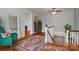 Hallway on second floor with natural light from the front window and colorful area rug at 9929 Kerns Rd, Huntersville, NC 28078