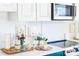 Kitchen showcasing white cabinets and a sleek cooktop stove at 9929 Kerns Rd, Huntersville, NC 28078