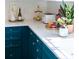 Bright kitchen counter top with decorative pieces and teal cabinets at 9929 Kerns Rd, Huntersville, NC 28078