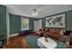 Inviting living room with wood floors, a map, and a leather sofa at 9929 Kerns Rd, Huntersville, NC 28078