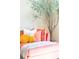 Inviting living room featuring coral sofa with throw blanket and accent pillows, plus olive tree at 9929 Kerns Rd, Huntersville, NC 28078