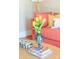 Bright living room with coral sofa, coffee table featuring books, flowers, and colorful decorative box at 9929 Kerns Rd, Huntersville, NC 28078