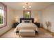 Elegant bedroom with a plush bed, stylish lighting, and soft neutral tones at 9929 Kerns Rd, Huntersville, NC 28078