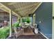 Cozy covered porch with comfortable seating and rustic wooden accents, perfect for relaxing outdoors at 9929 Kerns Rd, Huntersville, NC 28078