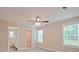 A bright bedroom with carpet flooring and ceiling fan leads to a walk-in closet and bathroom at 1028 Gibson St, Albemarle, NC 28001