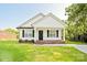 Charming single-story home with white siding, black shutters, and a well-manicured front lawn at 1028 Gibson St, Albemarle, NC 28001