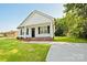 Charming single-story home with white siding, black shutters, and a welcoming front porch at 1028 Gibson St, Albemarle, NC 28001