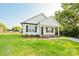 Beautifully landscaped front yard of a single-story home with white siding and black shutters at 1028 Gibson St, Albemarle, NC 28001