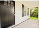 Close-up of a modern black front door and a concrete porch with brick trim at 1028 Gibson St, Albemarle, NC 28001