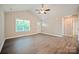 Bright living room with vaulted ceilings and gray flooring with a view of the entry door at 1028 Gibson St, Albemarle, NC 28001