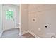 The mudroom with washer/dryer hookups is steps from the rear entry at 1028 Gibson St, Albemarle, NC 28001