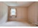Bedroom with neutral carpet, paneled wallpaper, and a window with curtains at 105 Hopewell Church Rd, Shelby, NC 28152