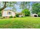 Quaint home with a well-manicured lawn, porch, and detached garage, ideal for outdoor living and storage at 105 Hopewell Church Rd, Shelby, NC 28152