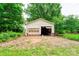 Exterior view of a detached garage surrounded by greenery at 105 Hopewell Church Rd, Shelby, NC 28152