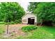 A detached garage is being renovated in a lush backyard, offering potential for storage or a workshop at 105 Hopewell Church Rd, Shelby, NC 28152