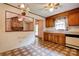 Open kitchen area with wood cabinets and a view to a brick fireplace at 105 Hopewell Church Rd, Shelby, NC 28152