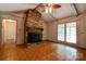 Living room with brick fireplace, ceiling fan, wood beams, and tile flooring at 105 Hopewell Church Rd, Shelby, NC 28152