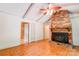 Living room with brick fireplace, ceiling fan, wood beams, and tile flooring at 105 Hopewell Church Rd, Shelby, NC 28152
