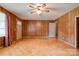 Living room featuring wood-paneled walls and parquet flooring at 105 Hopewell Church Rd, Shelby, NC 28152