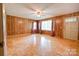 Sunlit living room with wood paneled walls and beautiful parquet flooring at 105 Hopewell Church Rd, Shelby, NC 28152