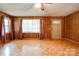 Sunlit living room with wood paneled walls and beautiful parquet flooring at 105 Hopewell Church Rd, Shelby, NC 28152