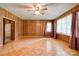 Bright living room featuring wood-paneled walls and parquet flooring at 105 Hopewell Church Rd, Shelby, NC 28152