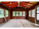 Enclosed sunroom needing renovation with rustic wood walls and multiple windows at 105 Hopewell Church Rd, Shelby, NC 28152