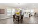 Bright dining room with wood floors, modern chandelier, and view of the kitchen at 1100 Herrons Ferry Rd, Rock Hill, SC 29730