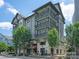 Three-story building featuring multiple balconies and ground-floor restaurants and businesses at 1100 Herrons Ferry Rd, Rock Hill, SC 29730