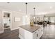 Open concept kitchen featuring a large island, stainless appliances and an adjacent dining and living space at 1100 Herrons Ferry Rd, Rock Hill, SC 29730