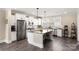 Open concept kitchen featuring stainless steel appliances, island with seating, white cabinets and gray countertops at 1100 Herrons Ferry Rd, Rock Hill, SC 29730