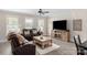 Inviting living room with plush seating, ceiling fan, and large windows for natural light at 1100 Herrons Ferry Rd, Rock Hill, SC 29730