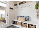Functional mudroom featuring a built-in bench, storage baskets, coat hooks, and neutral decor at 1100 Herrons Ferry Rd, Rock Hill, SC 29730