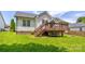 Backyard view featuring a wooden deck with stairs leading down to the grassy lawn at 1209 Danielle Downs Se Ct, Concord, NC 28025