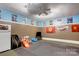 Finished basement featuring gray rubber flooring, mini refrigerator and a flat screen tv at 1209 Danielle Downs Se Ct, Concord, NC 28025