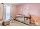 Bedroom with a gray crib, a chair and ottoman and natural light coming in from the window at 1209 Danielle Downs Se Ct, Concord, NC 28025