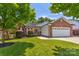 Charming brick and vinyl home with a well-manicured lawn and a two-car garage at 1209 Danielle Downs Se Ct, Concord, NC 28025