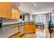 Bright kitchen with wood cabinets, stainless steel appliances, and a view to the dining area at 1209 Danielle Downs Se Ct, Concord, NC 28025