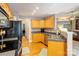Functional kitchen featuring oak cabinets and black appliances, perfect for cooking at 1209 Danielle Downs Se Ct, Concord, NC 28025