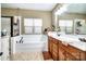 Bright bathroom with a soaking tub, double sink vanity, and neutral color scheme at 128 Aztec Cir, Mooresville, NC 28117