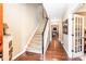 Welcoming foyer with hardwood floors, staircase, and a view into the living room at 128 Aztec Cir, Mooresville, NC 28117