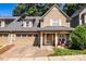 Charming two-story home featuring a covered front porch, brick driveway, and a two-car garage at 128 Aztec Cir, Mooresville, NC 28117