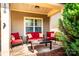 Inviting covered front porch featuring stylish seating and a charming stone floor at 128 Aztec Cir, Mooresville, NC 28117