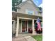 Charming front porch with patriotic decor, cozy seating, and inviting entrance at 128 Aztec Cir, Mooresville, NC 28117