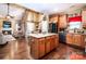 Open concept kitchen with large island, stainless steel appliances, and hardwood floors at 128 Aztec Cir, Mooresville, NC 28117