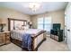 Cozy bedroom with a decorative bed frame, neutral carpet, and soft lighting at 128 Aztec Cir, Mooresville, NC 28117