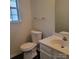 A half bathroom has modern sink and faucet, a toilet and window with natural light at 13039 Peacock Ln, Charlotte, NC 28215