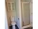 Bathroom with a toilet, shower, and a cabinet for storage at 13039 Peacock Ln, Charlotte, NC 28215